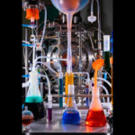 Diagram illustrating Big Bang nucleosynthesis within Lava-Void Cosmology, showing post-bounce turbulent dissipation reheating a unified relativistic viscous fluid to a radiation-dominated plasma state, leading to conventional nuclear freeze-out and light element abundances during quasi-de Sitter to matter-like transitions