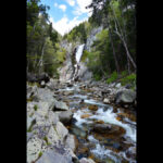 Artistic visualization of the thermodynamic arrow of time in Lava-Void Cosmology, depicting a cascading waterfall symbolizing irreversible dissipative processes in density-dependent bulk viscosity and multifractal turbulence within a unified relativistic viscous fluid across a non-singular bounce