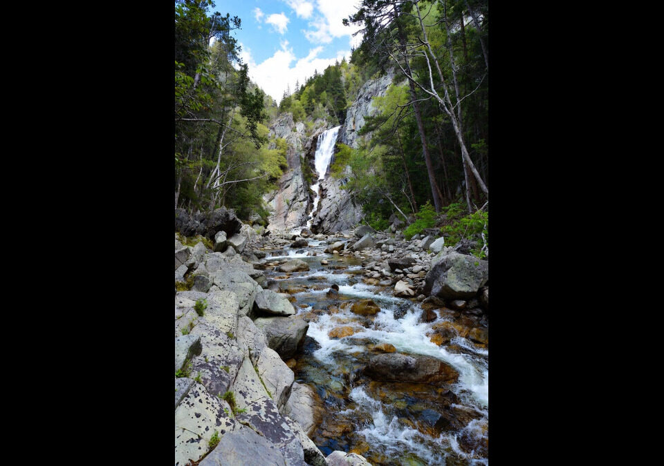 Artistic visualization of the thermodynamic arrow of time in Lava-Void Cosmology, depicting a cascading waterfall symbolizing irreversible dissipative processes in density-dependent bulk viscosity and multifractal turbulence within a unified relativistic viscous fluid across a non-singular bounce