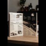 Open book showing timeline of physics history from ancient Greece to Lava-Void Cosmology, spanning Thales, Newton, Einstein, quantum mechanics, and modern cosmology