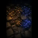Old case files and faded photographs of children on a dark table, overlaid with separate gold and blue network clusters instead of one single pattern.