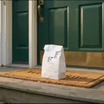 A little white Rx pharmacy bag delivered to the front porch